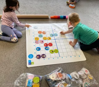 zdjęcie dzieci podczas nauki i zabawy z wykorzystaniem pomocy naukowych - klocków